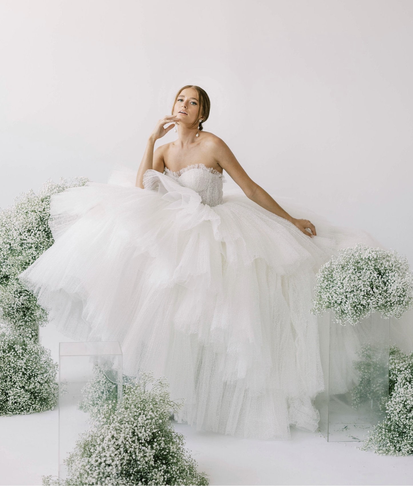 models wearing white wedding gowns